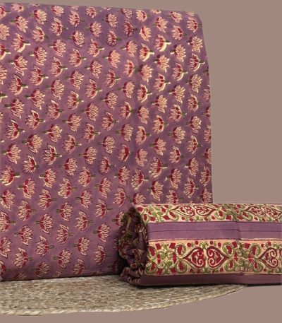 This 2pc unstitched fabric set includes a Blockprinted Soft Cotton top and matching bottom fabric in a pink lotus repeat with a coordinating ornate paisley border print design. Soft