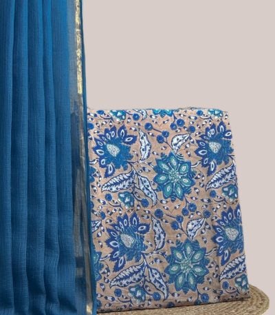 This blue unstitched suit fabric set includes a 2.50 metre AirLoom™ Kota dupatta paired with a 2.50 metre Blockprint Soft Cotton top fabric. Ideal for custom tailoring into your preferred silhouette. [Internal note: Colour taken as top fabric's dominant floral tone (Blue) over its beige base - please confirm.]