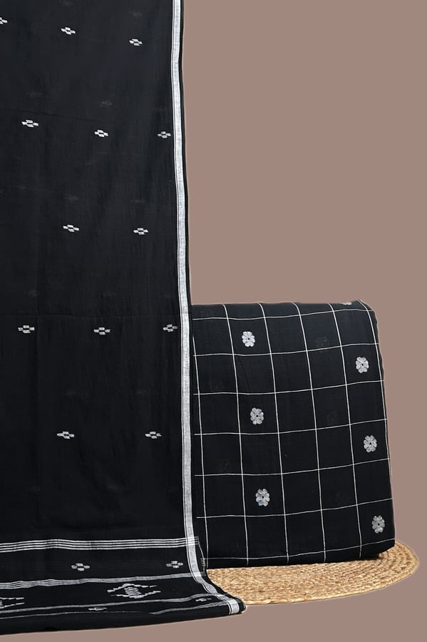 This black unstitched suit fabric set includes a 2.50 metre Handloom Cotton dupatta paired with a 2.50 metre Handloom Woven Design Cotton top fabric. Ideal for custom tailoring into your preferred silhouette.