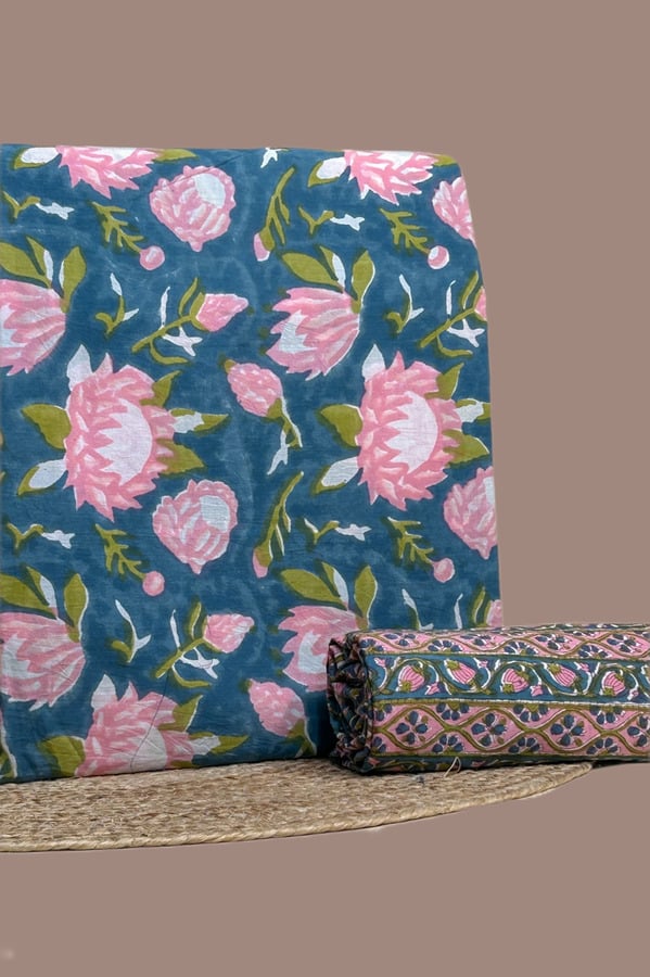 This blue unstitched fabric set includes a 2.50 metre Blockprint Soft Cotton top and a 2.50 metre Blockprint Soft Cotton bottom. No dupatta included in this set. [Internal note: Original read showed this as a draped dupatta + rolled top pairing (teal floral + olive/pink border)