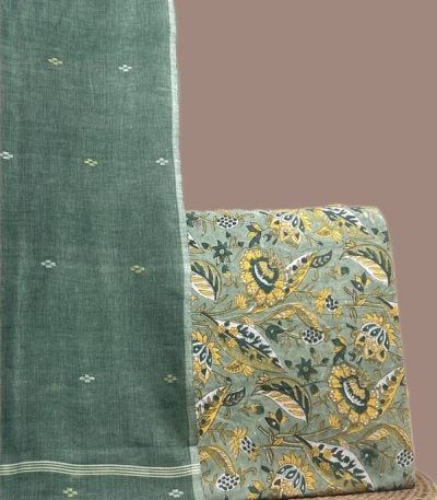 This green unstitched suit fabric set includes a 2.50 metre Handloom Cotton dupatta paired with a 2.50 metre Blockprint Soft Cotton top fabric. Ideal for custom tailoring into your preferred silhouette.