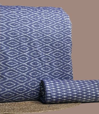 A coordinated blue Ikkat pairing — patterned top fabric with a complementary Ikkat bottom in a smaller motif
