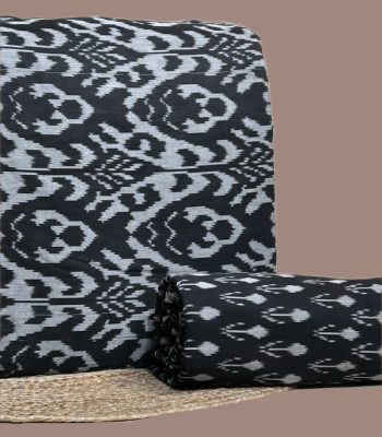 A coordinated black Ikkat pairing — patterned top fabric with a complementary Ikkat bottom in a smaller motif