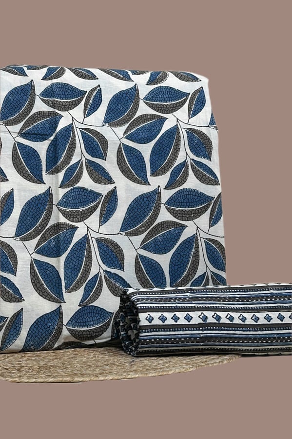 A white Ajrakh set with a printed top fabric and a coordinating Ajrakh bottom in a contrasting motif