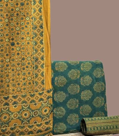 A green three piece Ajrakh set with a bordered printed dupatta