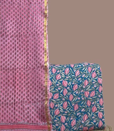 Pink buti blockprint dupatta with gold zari border and a teal top in pink leaves.