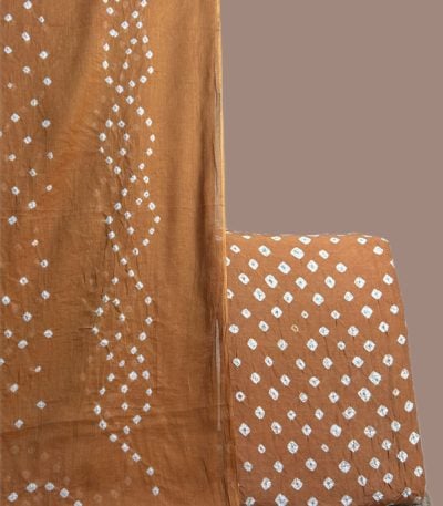 Rust bandhani dupatta in wave tie dye with a matching rust dotted bandhani top.